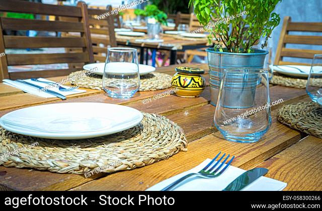 Sun terraces with empty glass glasses and table set to eat or have a snack in Marbella, Malaga, Spain