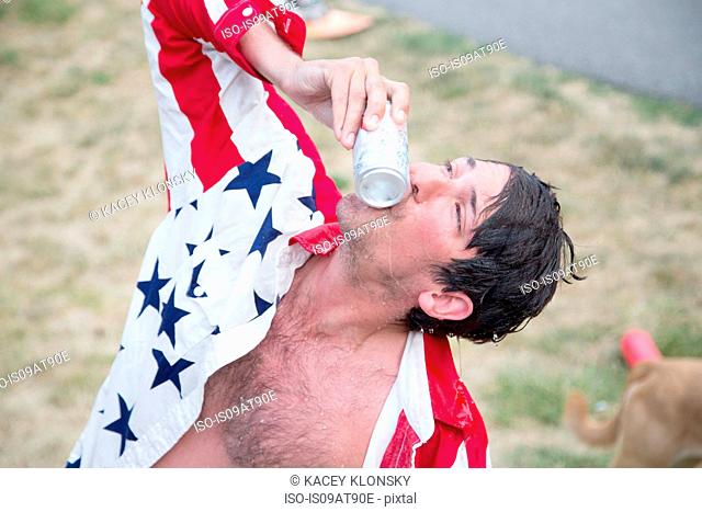 Young man kissing beer can celebrating Independence Day, USA
