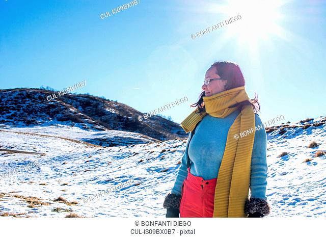 Woman in snow landscape, Piani Resinelli, Lombardy, Italy