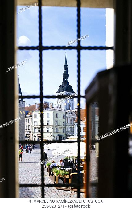 The town hall square seen from a pharmacy window and the bell tower of the church of St. Nicholas. Tallinn, Harju County, Estonia, Baltic states, Europe