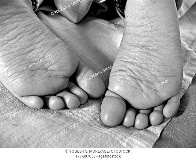 Close-up of a child's feet sleeping in a bed