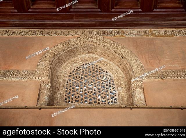 Perforated arched stucco window decorated with geometrical patterns and calligraphy at Ibn Tulun mosque, Old Cairo, Egypt