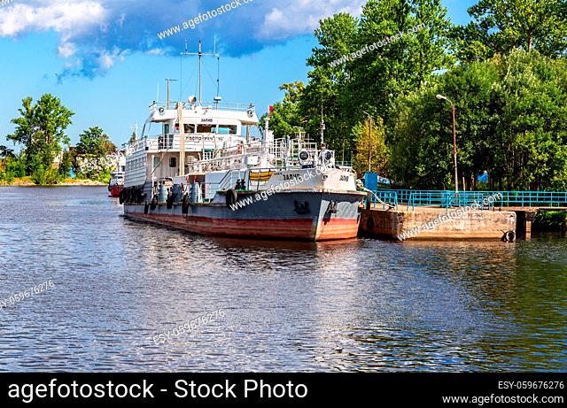 Shlisselburg, Russia - August 8, 2018: Ship is at the quay wall of the river port in sunny day