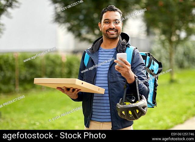 food delivery man with takeaway pizza and phone