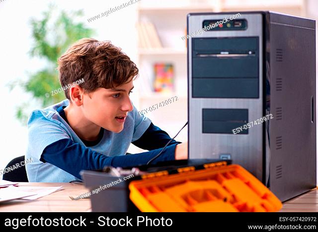 Teenager reparing computers at workshop