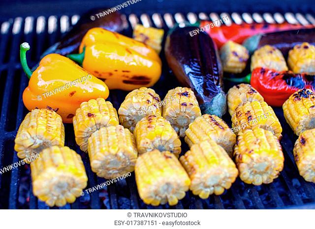 Vegetarian barbecue and cobs of corn on the grill outdoors