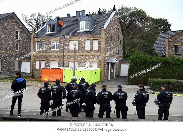 25 October 2018, North Rhine-Westphalia, Manheim: Policemen stand in front of a house occupied by opponents of brown coal