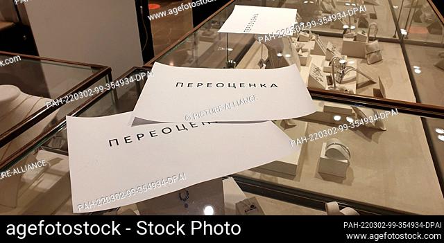 02 March 2022, Russia, Moskau: In the Moscow luxury department store ZUM on a showcase there are slips of paper informing customers that the prices of jewelry...