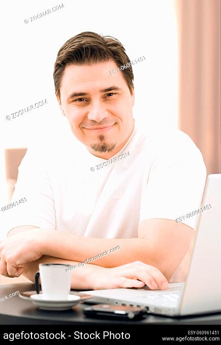 Adult man working on laptop computer at home