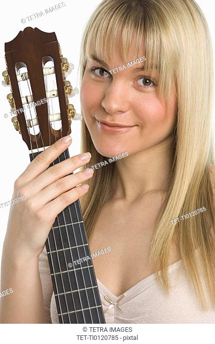 Studio shot of woman with guitar