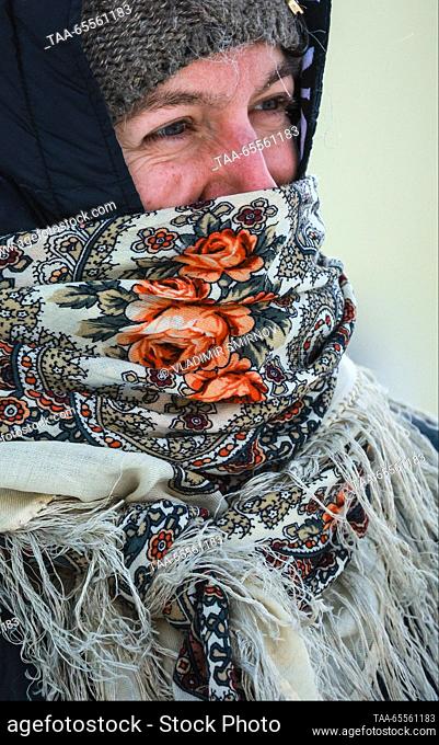 RUSSIA, VLADIMIR REGION - DECEMBER 8, 2023: A woman wrapped in a woolen scarf in the town of Suzdal on a frosty winter day