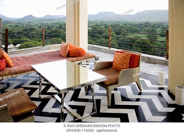 Black & white marble flooring also chairs and bed in balcony restful luxury royal setup in rich palace Devigadh turned in hotel ; Village Dilwara ; Udaipur ;...