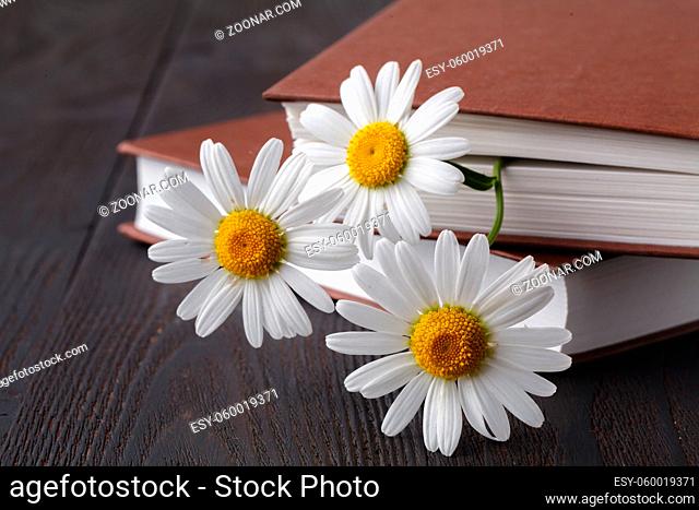 books with bouquet of flowers