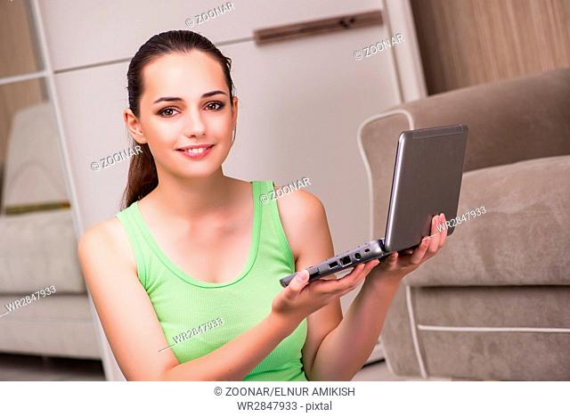 Young woman working at laptop at home