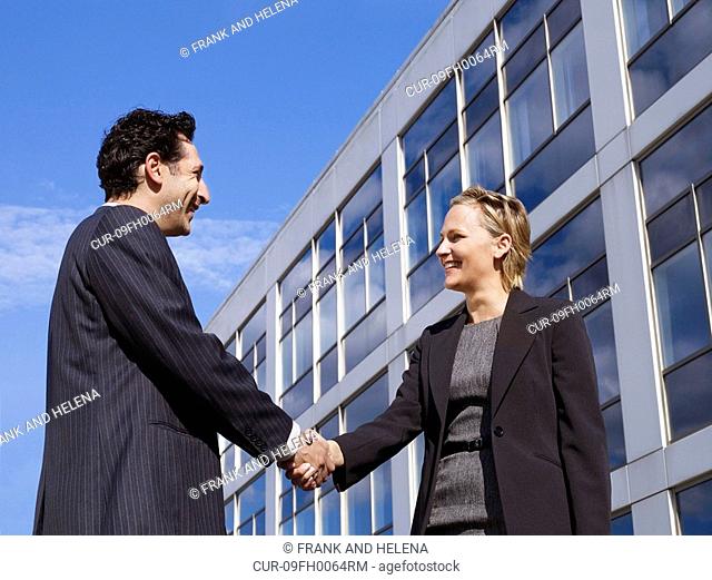 Business man & woman in front of office