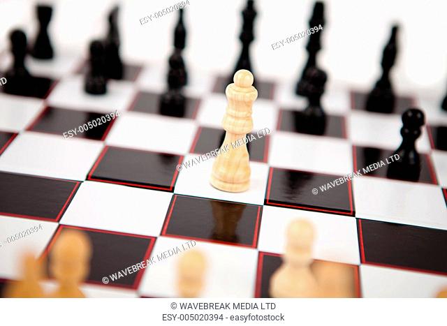 White queen standing the middle of the chessboard