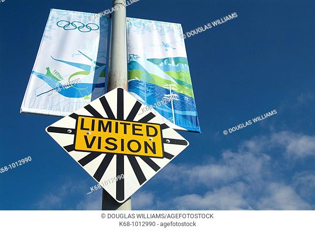 road sign and Olympic banners, Limited Vision, on the Granville Street Bridge, Vancouver, BC, Canada