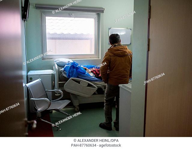 Saad Najm Mahmud waits by the bed of his wounded Wakas in the West Erbil Emergency Hopsital in Erbil, Iraq, 03 February 2017