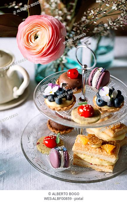 Various pastries on glass etagere