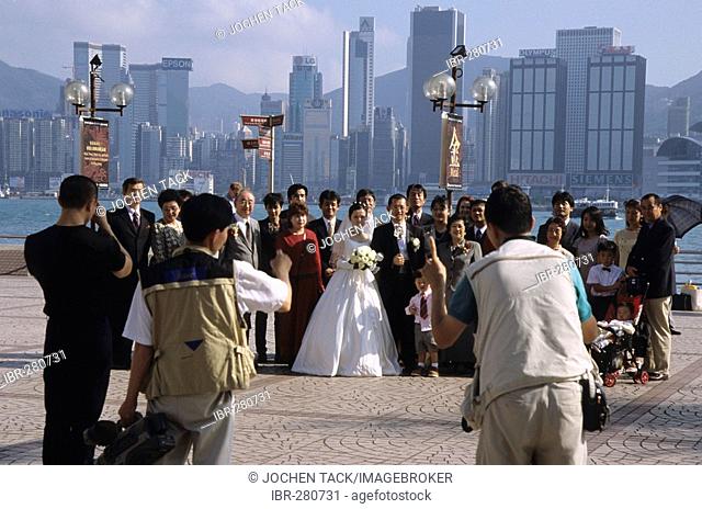 Wedding party taking a group photo, Kowloon Public Pier, Hong Kong, China