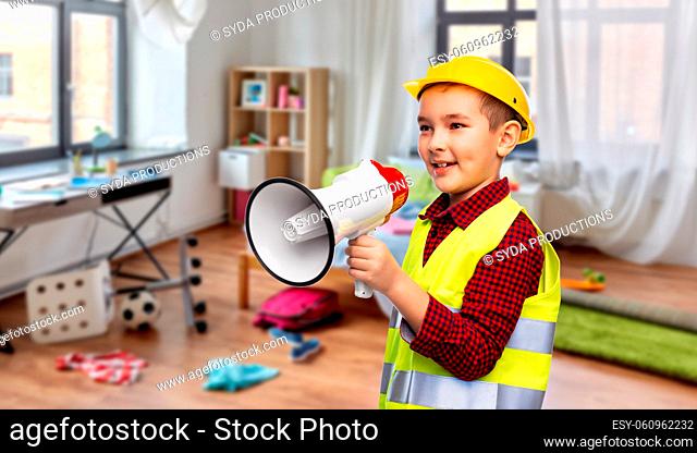 boy in protective helmet talking to megaphone