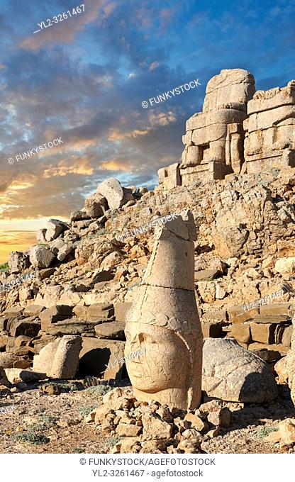 Statue head at sunrise of Apollo in front of the stone pyramid 62 BC Royal Tomb of King Antiochus I Theos of Commagene, east Terrace