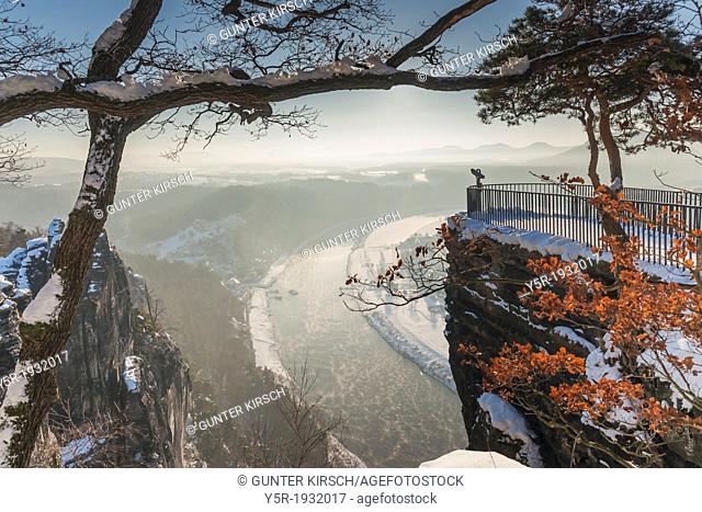 View from the spectacular rock formation Bastei (Bastion) to health resort Rathen and the Elbe River. The Bastei is one of the most visited tourist attractions...