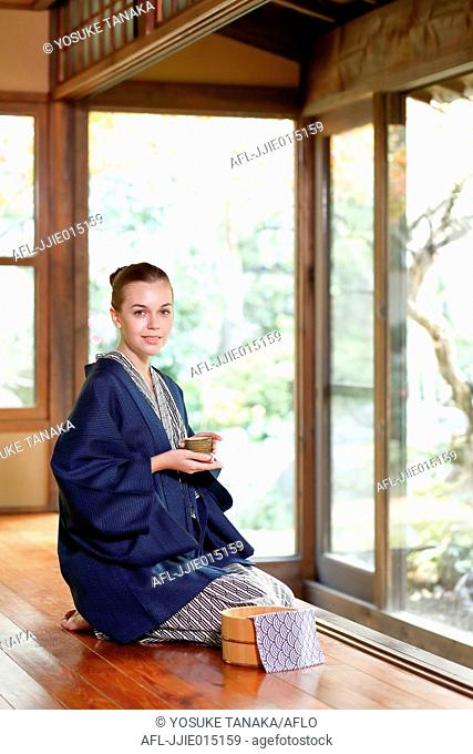 Caucasian woman wearing yukata at traditional ryokan, Tokyo, Japan