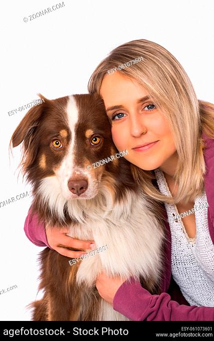 Young woman with australian shepherd dog on white background