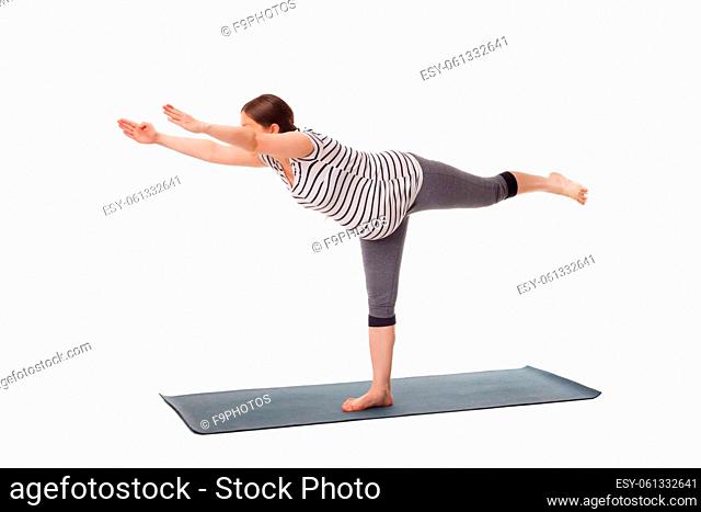 Pregnancy yoga exercise - pregnant woman doing asana virabhadrasana 3 - warrior pose isolated on white background