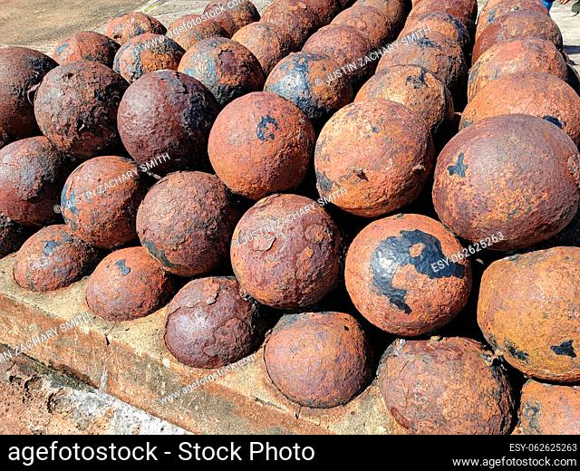 large pile or stack of rusted iron cannon balls