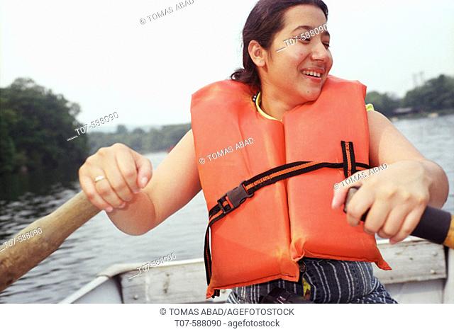 Latino woman rowing boat