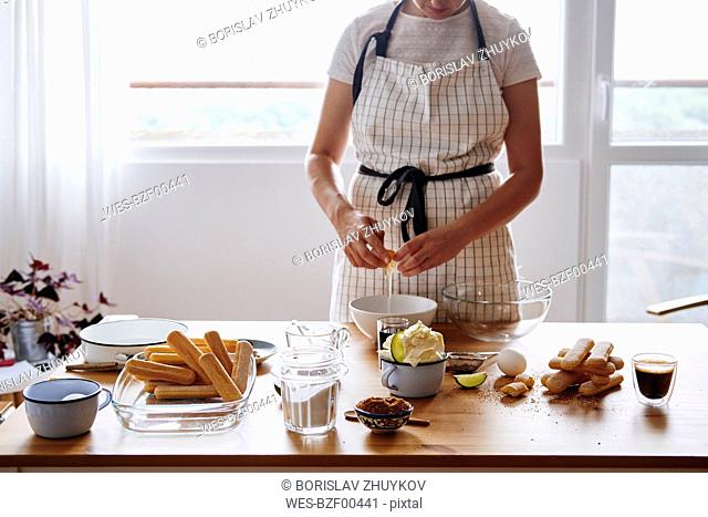 Woman separating egg for preparing Tiramisu