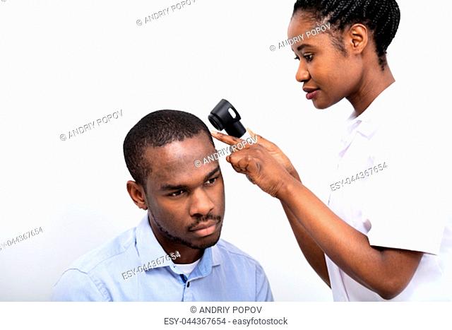 Young African Doctor Man's Hair With Dermatoscope On White Background