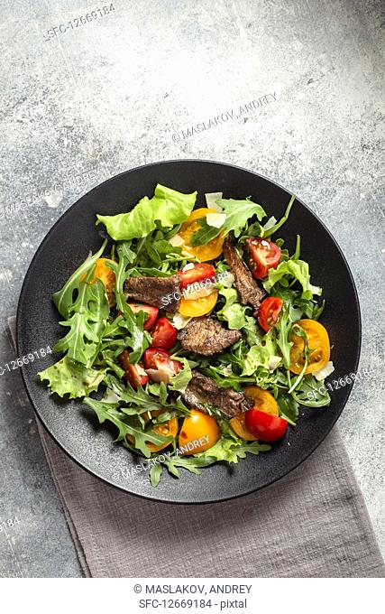 Arugula salad with seared beef cheese and tomatoes