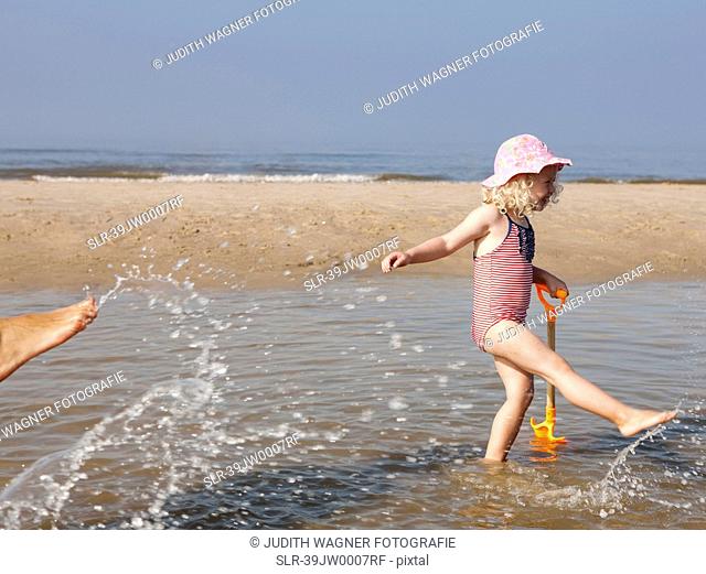 Child playing in water at beach