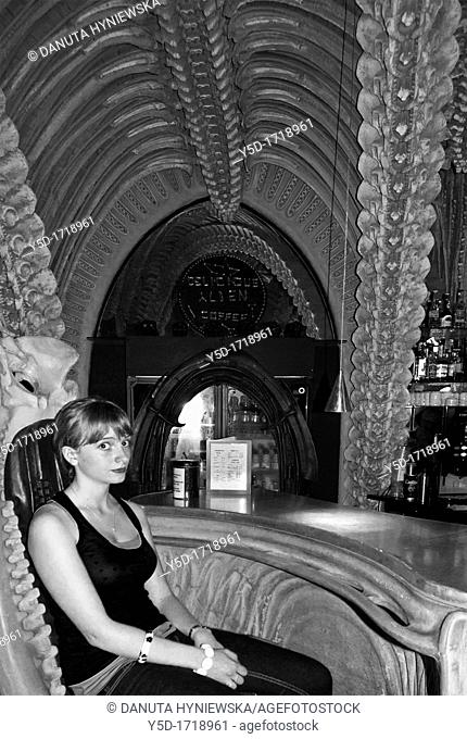young woman in H R  Giger Museum Bar in Gruyères, District Gruyère, Canton of Fribourg, Switzerland
