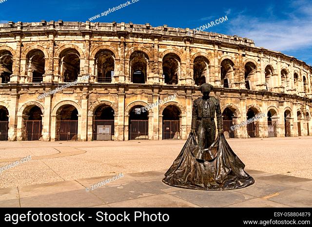 Nimes, France - 15 March, 2021: view of the Roman amphitheater in Nimes with the statue of the bullfighter Nimeno