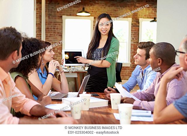 Female Boss Addressing Office Workers At Meeting