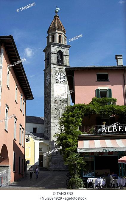 Sidewalk cafe in front of clock tower, San Pietro Church, Ascona, Switzerland