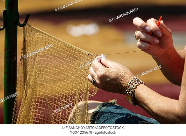 Woman mending fishing nets. Castro Urdiales, Cantabria