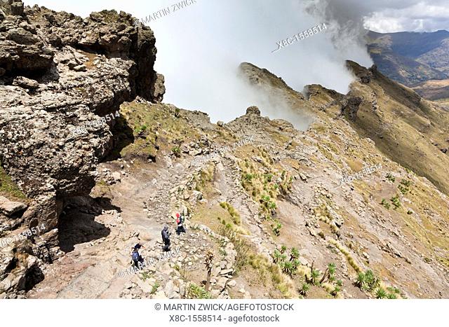 Trekking in the Simien Moutains NP, Ethiopia  Clouds are moving up at the edge of the escarpment forming a dramatic background  The Simien Semien, Saemen