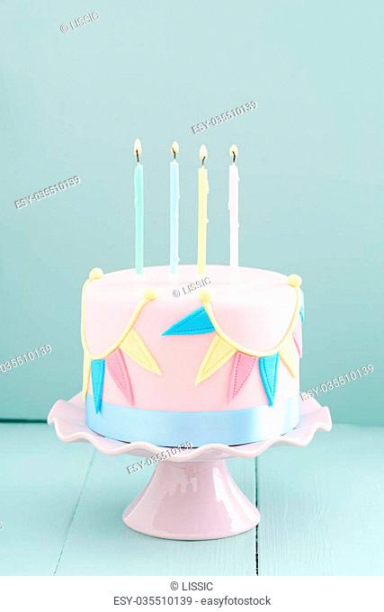 Fondant covered pastels coloured birthday cake with buntings and balloons