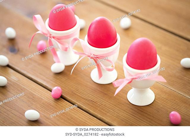 easter eggs in holders and candy drops on table
