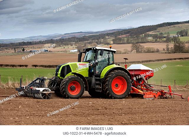 Claas Axion 810 tractor with seed drill and press on and top soil blowing. (Photo by: Wayne Hutchinson/Farm Images/UIG)