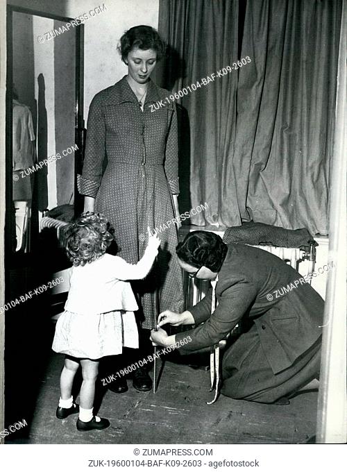 1955 - Little Jennifer Davis, aded 18 months, watches closely as her mother, Mrs. JB. Davis tries on the dress she is making for herself, while Miss H