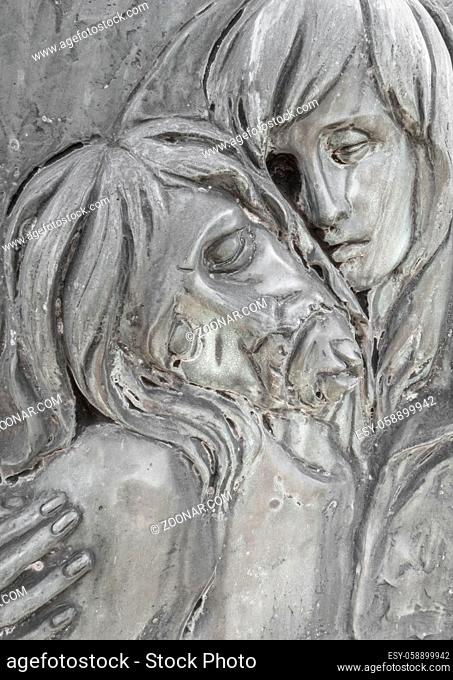 Bas-relief in bronze representing The Pity of Michelangelo. Faces of Holy Mary mother and Jesus Christ after the Crucifixion