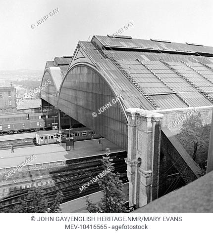 An elevated view showing the north end of the train shed at Brighton station with trains visible on the external platforms beneath and the townscape to the east