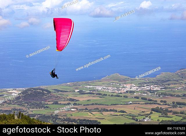 Paragliders after take-off from Pico Barrosa with a view over the island of Sao Miguel, Azores, Portugal, Europe