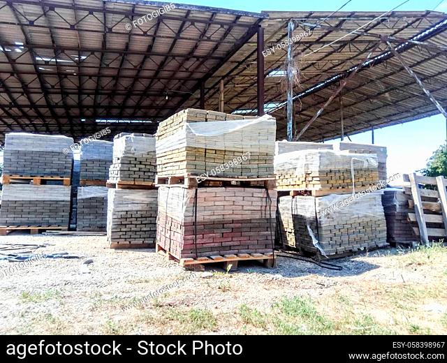 Tiles piled in pallets. Warehouse paving slabs in the factory for its production